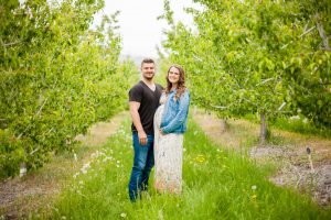 formal image of man and wife standing in orchard