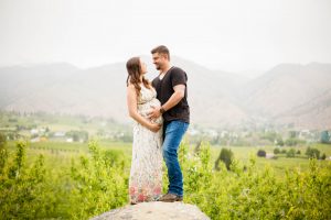 couple standing on boulder
