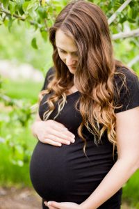 closeup of pregnant woman holding belly