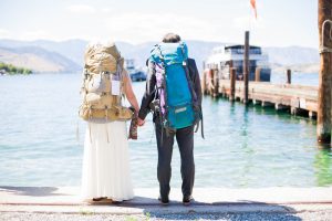 backpacking couple looking at lake chelan with backs toward camera